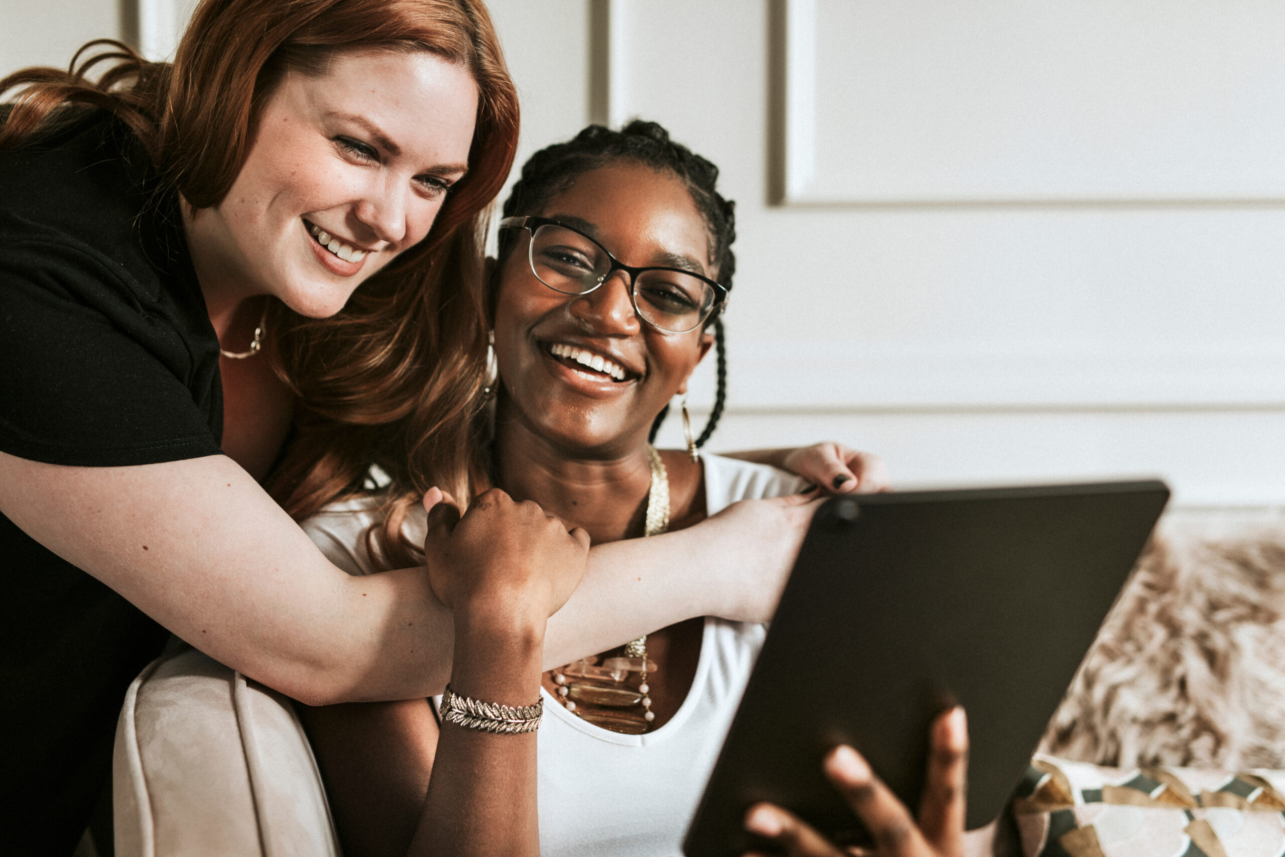 Lesbian couple taking a selfie with a digital tablet