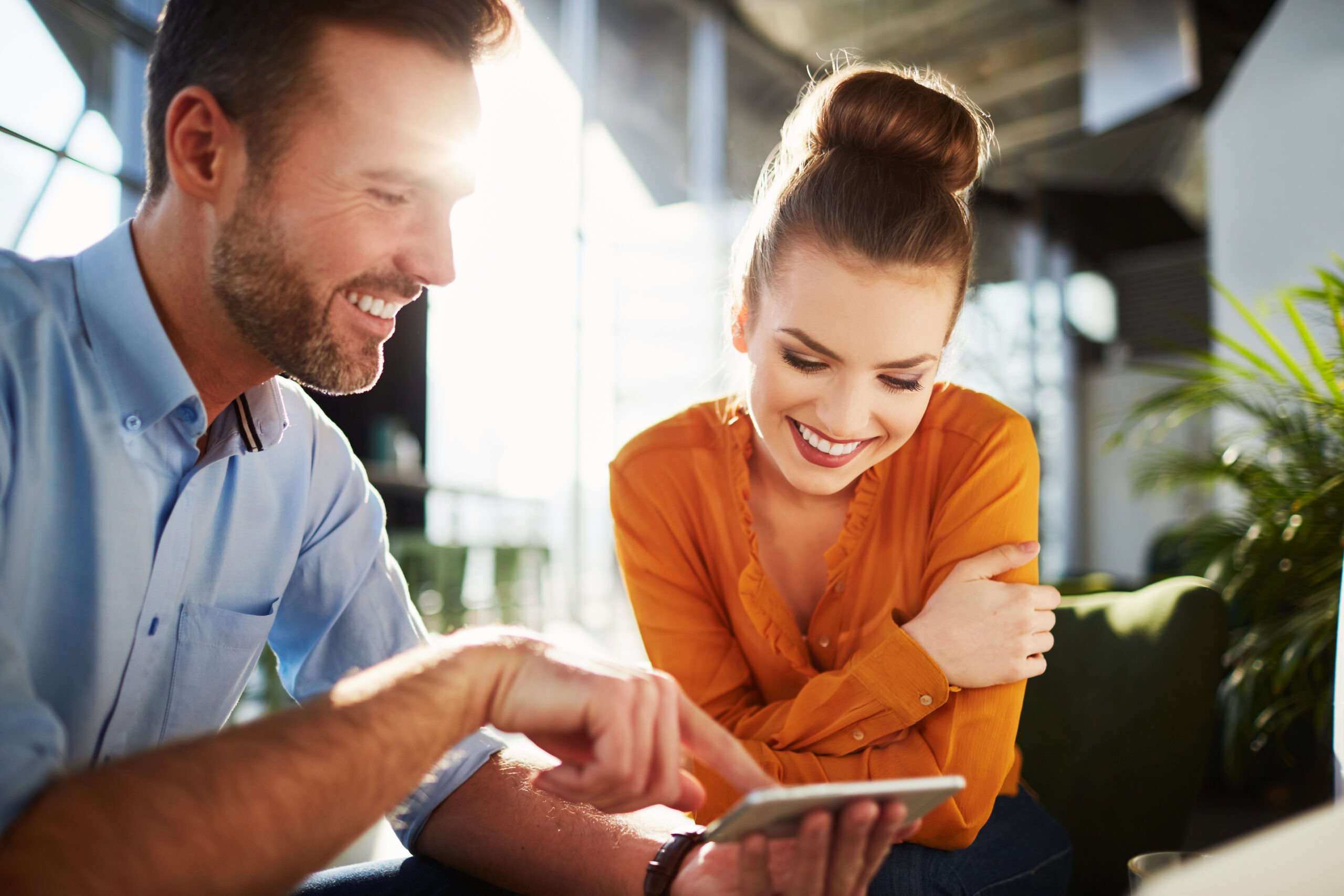 Man and woman watching a video