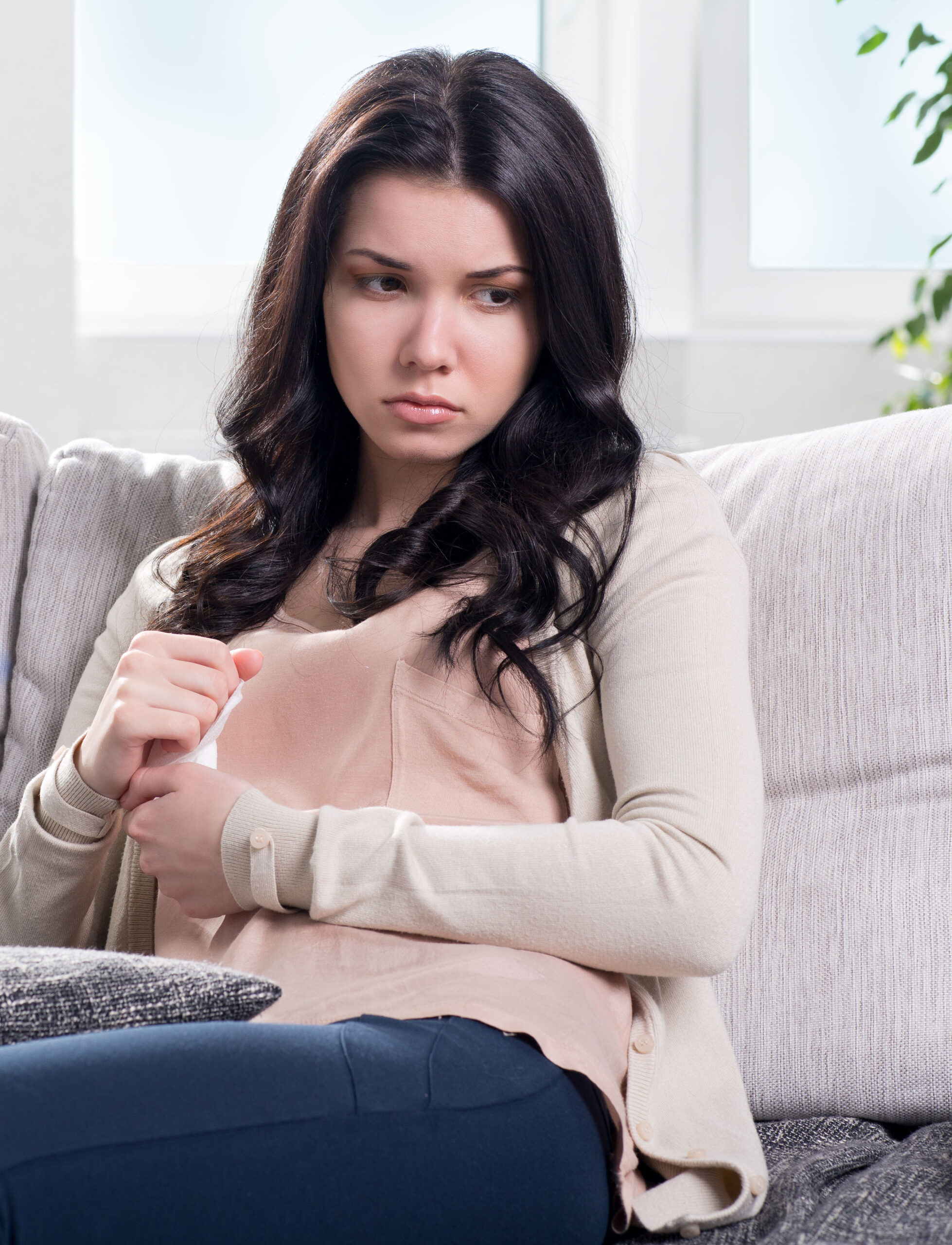 depressed young woman on couch at the psychologist